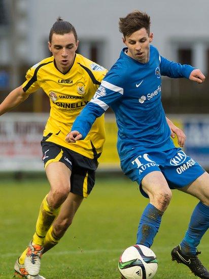 Jamie Glackin of Dungannon moves in to challenge Ballinamallard United's David Elliott during the 1-1 draw in the Irish Premiership