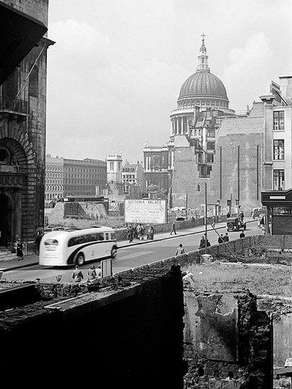 Looking south-west across bomb-damaged buildings on Cheapside towards St Paul's cathedral