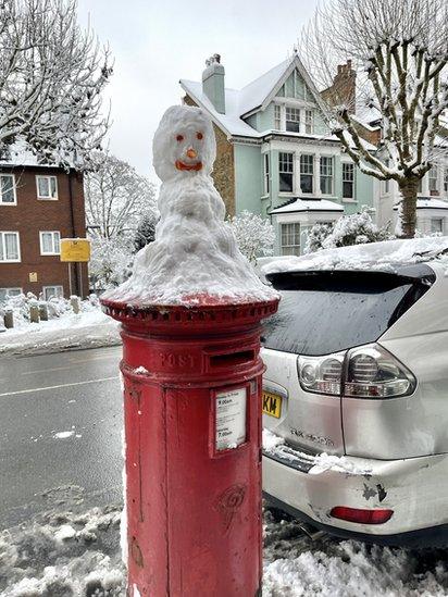 Snowman on top of a Post Box in Muswell Hill, London