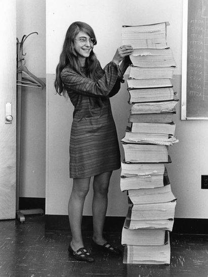 Margaret Hamilton with a stack of code