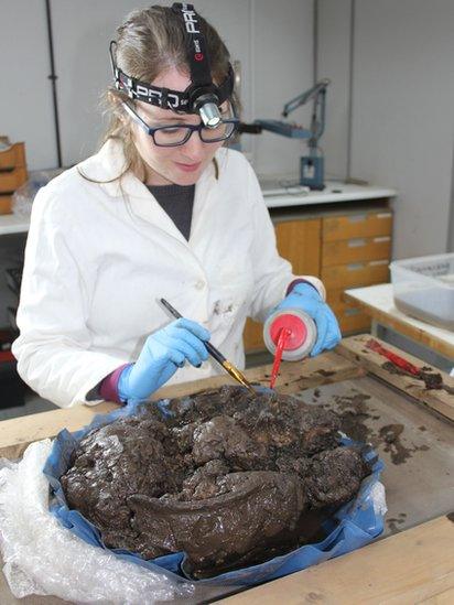 Archaeologist working on bowl