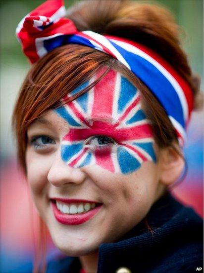 Royal enthusiast from Bedfordshire poses at the junction of the Mall and Horse Guards Road