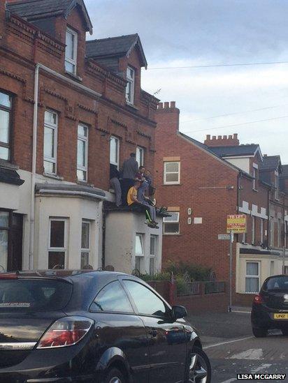 Youths on roof in Holylands, Belfast, 20 September 2016