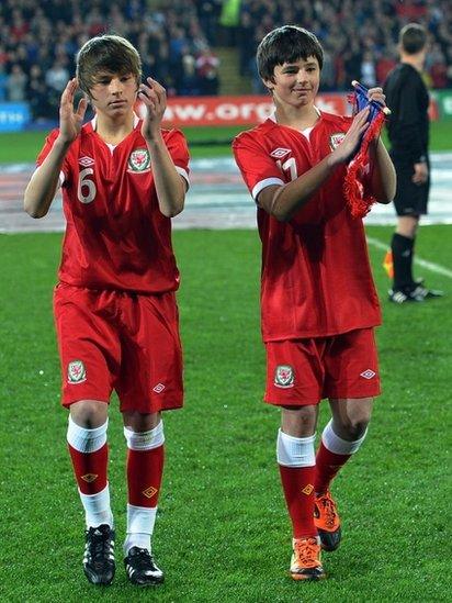 Tommy and Ed Speed, children of Gary Speed leave the pitch before the Gary Speed Memorial Match, a friendly international football match between Wales and Costa Rica at The Cardiff City Stadium in Cardiff. Pic: PAUL ELLIS/AFP/Getty Images