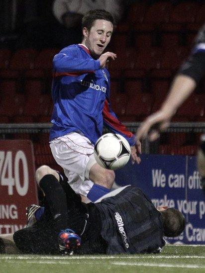 Linfield's Michael Carvill has a penalty appeal turned down after this incident with Crues keeper Craig Hyland