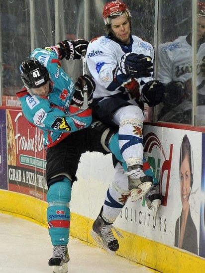 Adam Keefe of the Belfast Giants puts a big check on Michal Benadik of the Edinburgh Capitals