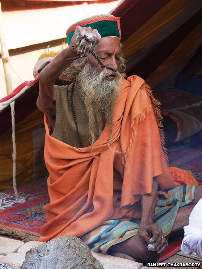 A holy man with arm held aloft. Photo: Ranjeet Chakraborty