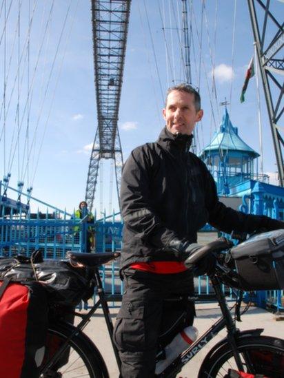 Rob Graham, who is beginning a 12,000 mile bicycle ride to New Zealand, at the Newport Transporter Bridge