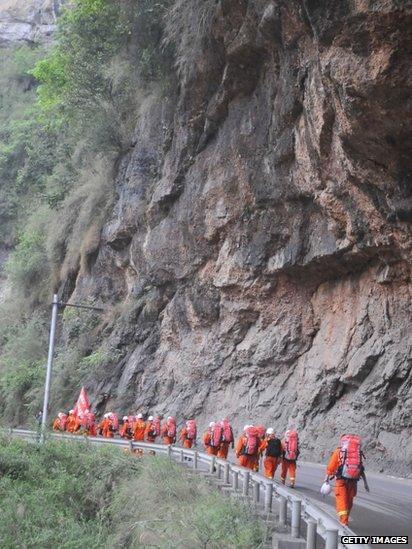 Rescuers on foot head for Baoxing County, Sichuan province, China (21 April 2013)