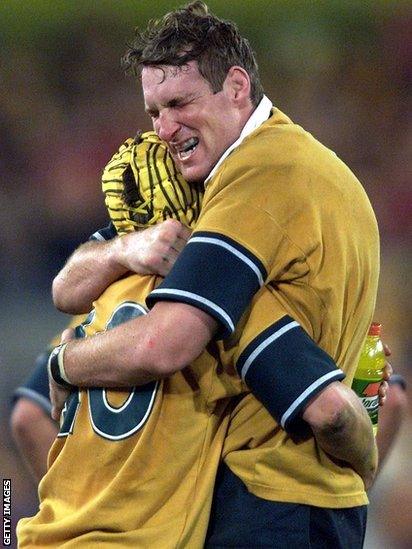 Justin Harrison (right) embraces Elton Flatley after Australia's win in Sydney