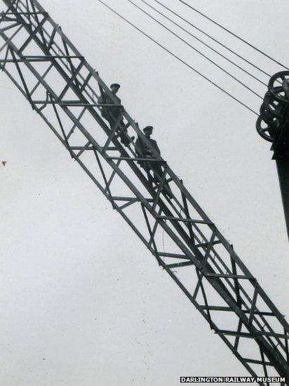 Men sitting on a bridge