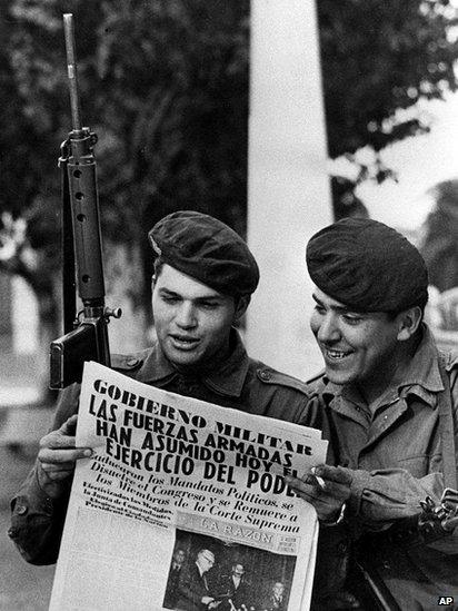 Two army soldiers read a newspaper in the Buenos Aires Plaza de Mayo March 24, 1976 after a military coup led by Gen Jorge Rafael Videla ousted President Isabel Peron.