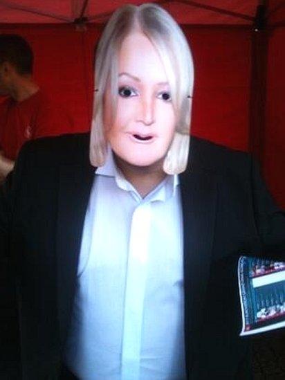 A member of the public wearing a Bonnie Tyler mask