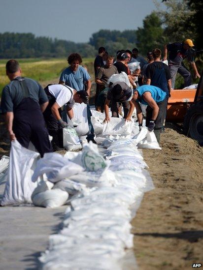 Volunteers build a temporary dam alongside the banks of the Danube, in Mecser, 150 km north-west of Budapest, Hungary, 6 June 2013