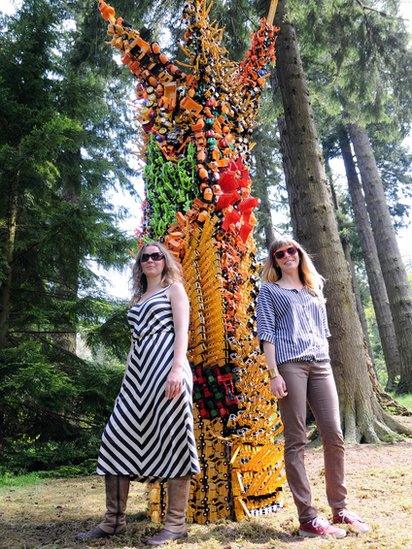 Two women stood in front of a frame