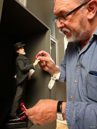 Animator Barry Purves placing his Tchaikovsky puppet in the display case