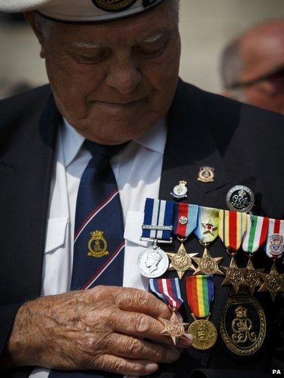 Harold Turtle, 91, from the Isle of Wight looks down at his Arctic Star medal after receiving it for the second time during the Armed Forces Day Parade in Portsmouth.