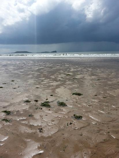 A view across Rhossili beach on Gower, Swansea, to Worm's Head