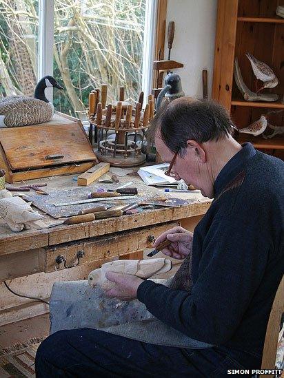 John Davies carving a bird in his workshop