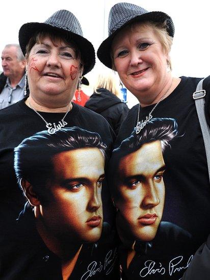 Two women at the Elvis festival wearing T shirts with the star