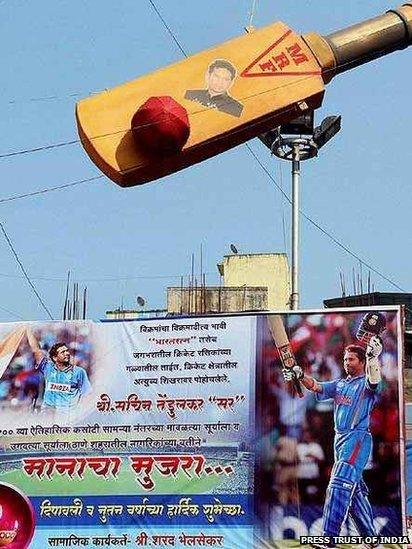 A fan of Sachin Tendulkar installed a bat and hoardings near Thane railway station in Mumbai