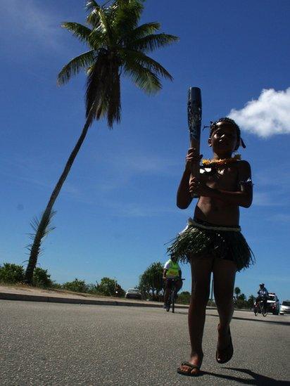 A young boy carries the baton on the small island of Nauru.