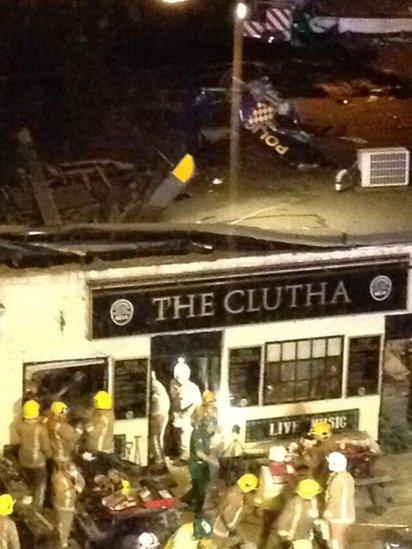 Wreckage of helicopter visible on pub roof