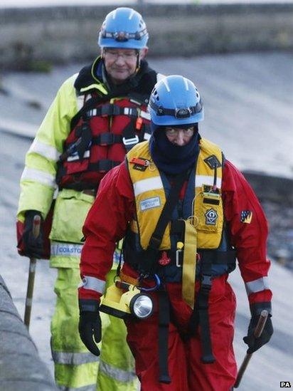 Coastguard officer searches the shoreline near Cramond