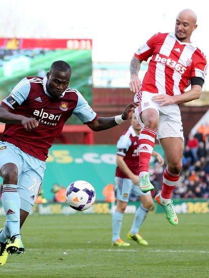 Guy Demel of West Ham United battles with Stephen Ireland of Stoke City during the Barclays Premier League match between Stoke City and West Ham United