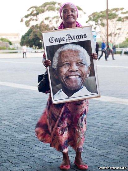 Woman holding poster of Nelson Mandela