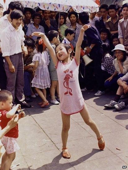 A young girl dances in Tiananmen Square on 1 June 1989