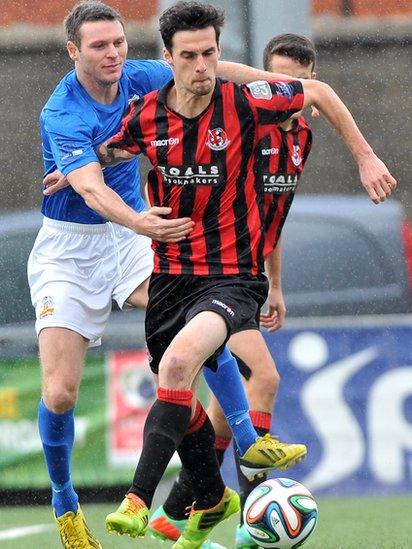 Kevin Braniff, who scored twice in Glenavon's away win over Crusaders, challenges Declan Caddell