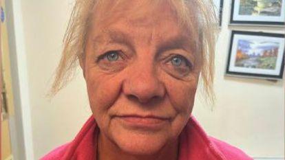 Tina Potter. She has blonde hair and blue eyes and is wearing a pink top