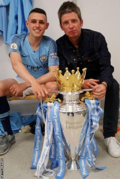 Phil Foden and singer Noel Gallagher with the Premier League trophy