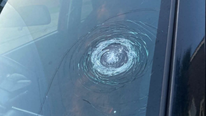 Sławosz's windscreen with a large circular crack on the side of it
