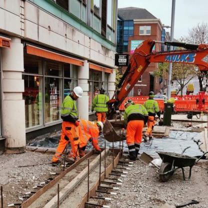 Workmen laying a new pavement