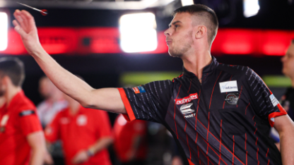 Dominic Taylor throws a dart