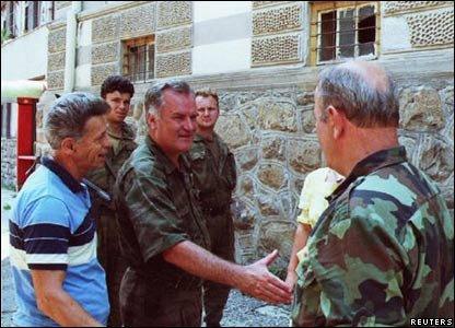 Mladic (C) shakes hands with a Bosnian Serb army soldier in the eastern Bosnian town of Srebenica July 13. Bosnian Serb forces took control of the town late July 11, 1995