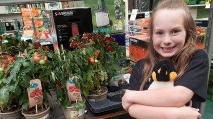 Harriet Thompson pictured in front of plants