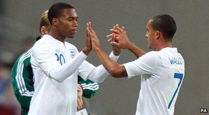 Walcott coming off, linking hands with Sturridge going on.