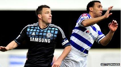 John Terry back-to-back with Anton Ferdinand going for a ball.