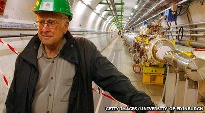 Man in hard hat stands in tunnel