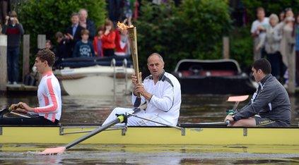 Sir Steve Redgrave carries Olympic flame.