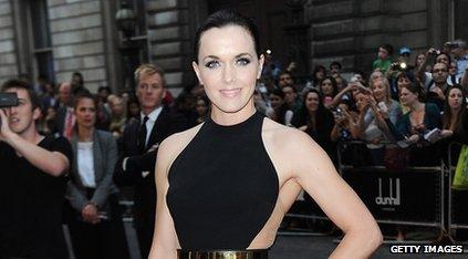 Cyclist Victoria Pendleton wearing a black dress and posing for the camera
