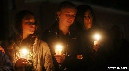 Girls at a candlelit memorial in Newtown