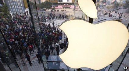 People line up to enter a newly-opened Apple Store