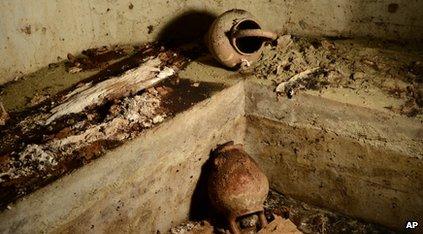 Tomb with vases and bones in it