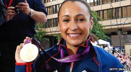 Jessica Ennis holds up her medal.