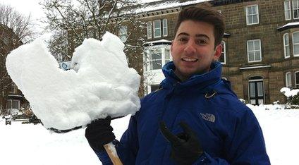 Ricky Boleto with a shovel full of snow.