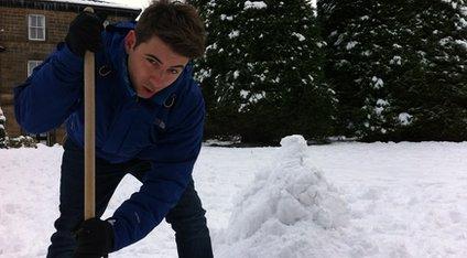 Ricky making a pile of snow.